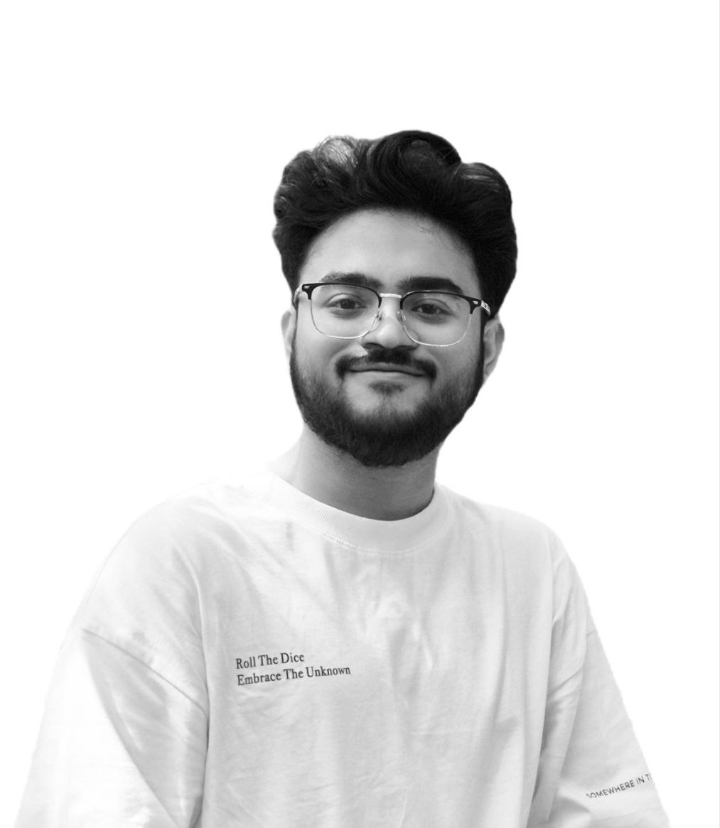 Parvez Ahmed, smiling, in glasses and a white t-shirt