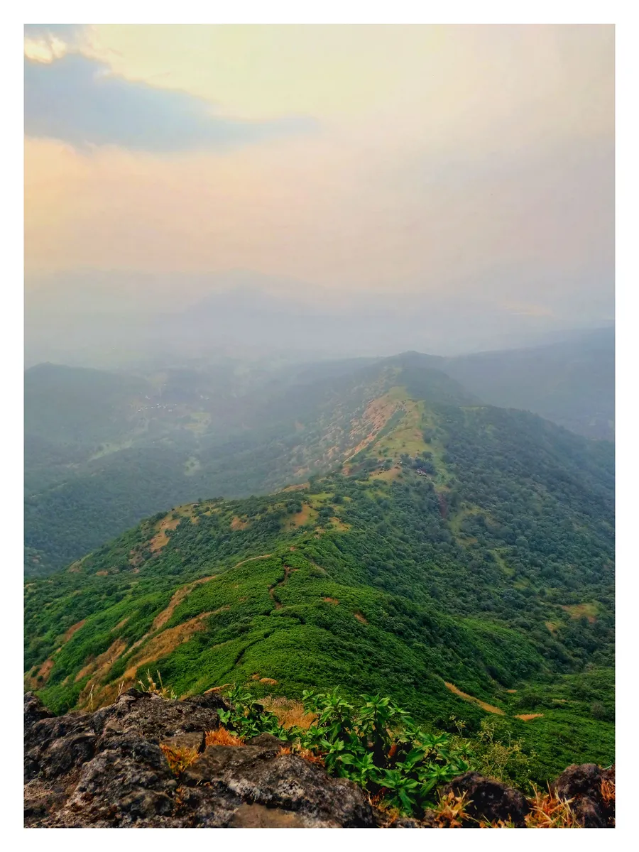 A green ridge fading into haze from the top of a fort
